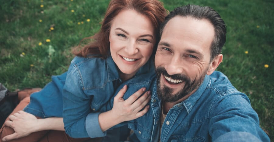 man and woman smiling after PELLET HORMONE REPLACEMENT THERAPY