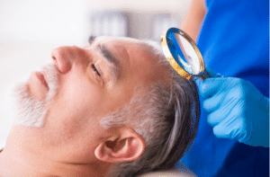 man visiting young male doctor in hair transplantation