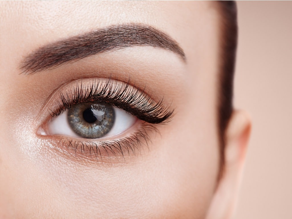 Female eye with long eyelashes, example of potential FaceTite treatment results.