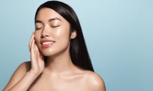A woman touching her cheek after a Morpheus8 treatment in Chicago