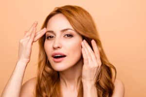 A woman looking at the results of a brow lift with Ultherapy