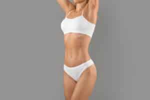 A woman posing in white underwear after radiofrequency skin tightening in Chicago