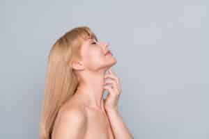 A profile shot of a woman after a FaceTite™ treatment in Chicago, IL