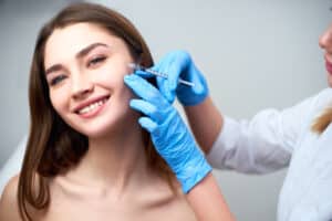A woman getting dermal fillers in her cheeks