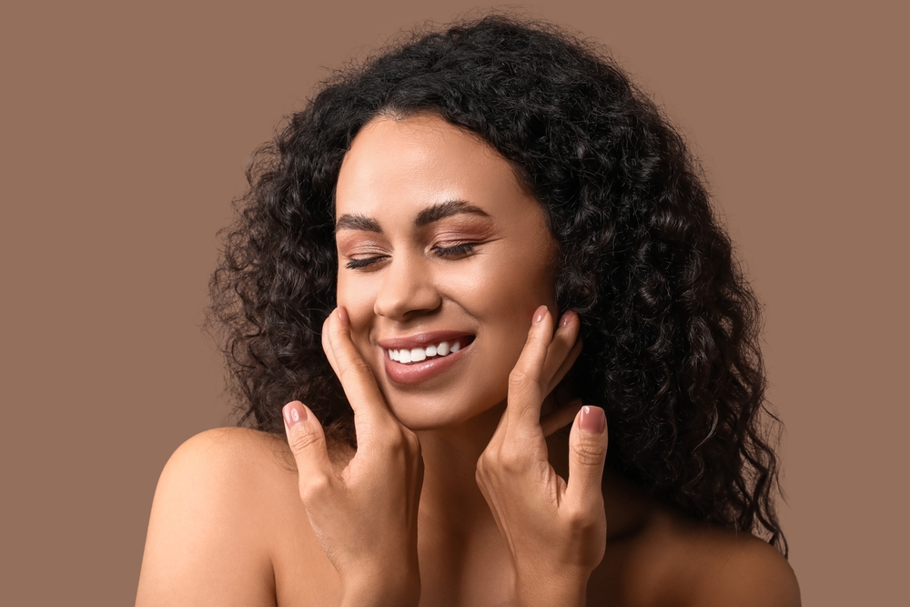 Woman with radiant skin smiling, representing Signature Facial at Old Town Med Spa.